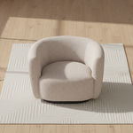 Beige armchair on a geometric-patterned rug with wooden floor